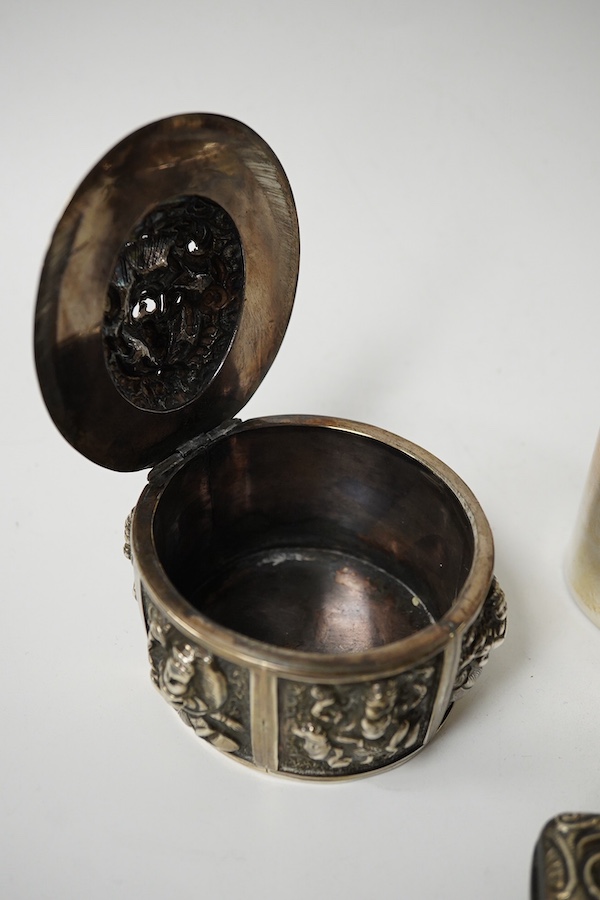 An Edwardian rectangular embossed silver mounted note case, leather lined, Goldsmiths & Silversmiths Co Ltd, London, 1901, 10.3cm, an oval silver tea caddy and cover and an Indian white metal circular box. Condition - po